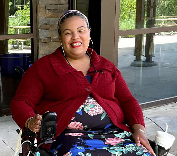 A woman on a wheel chair smiling