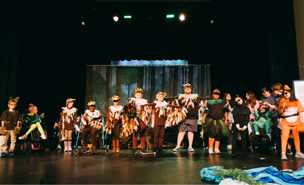 A crew of AWB actors on stage for a performance